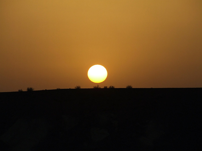 طلوع زیبای خورشید در افق پارک ملی کویر - کاروانسرای قصر بهرام